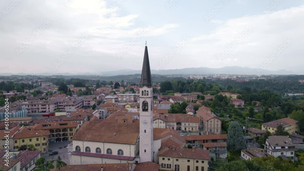 Aerial view of Lentate sul Seveso, a small town in Brianza, Italy. You can see the bell tower, mountains in the background and a lot of woods. Aerial view of Lentate sul Seveso, a small town in Brianza, Italy. You can see the bell tower, mountains in the background and a lot of woods.