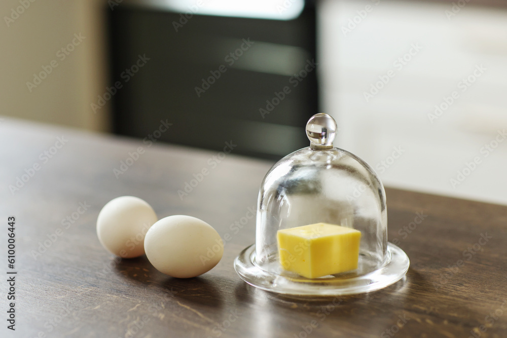 butter in a butter dish and eggs on a table butter in a butter dish and eggs on a table