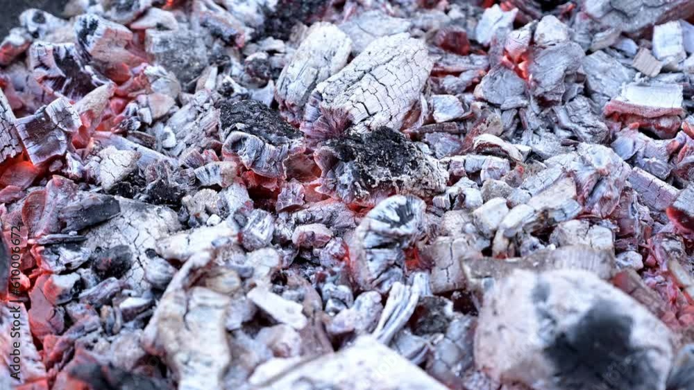 Hot, glowing charcoal briquettes on a barbecue grill, ready for cooking. Hot, glowing charcoal briquettes on a barbecue grill, ready for cooking.
