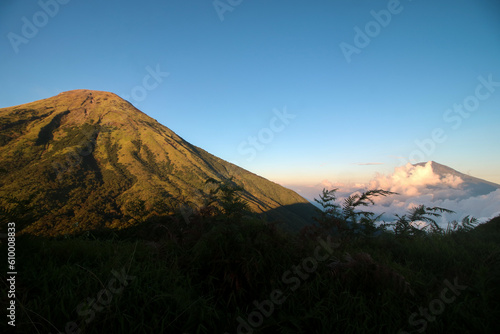 Sindoro mountain from top of mount kembang during sunset 