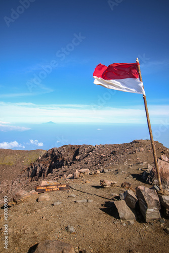 Indonesia national flag and signpost of the highest peak of Mount Slamet, Central Java, Indonesia. Mount Slamet is higest mountain in Central Java photo