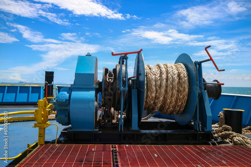 Mooring winch on a forward of a ferry with rope and chain in drum. Mechanical device equipment for ship mooring in port. Anchor winch mechanism in ship. windlass poop deck mooring rope photo