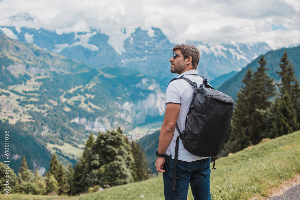 Young man hiking in Switzerland mountains