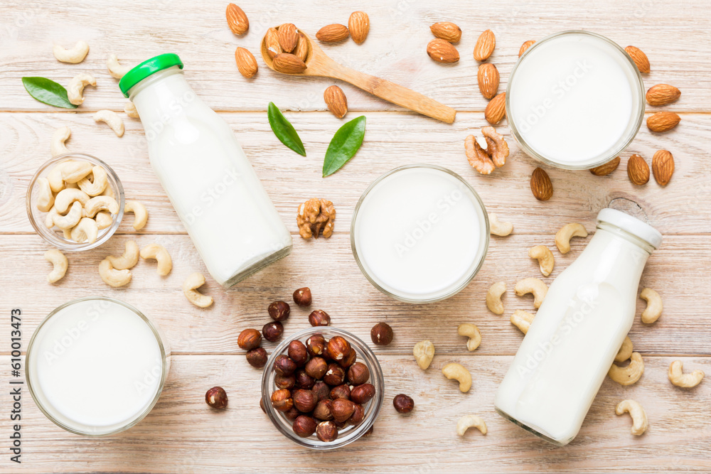 Set or collection of various vegan milk almond, cashew, on table background. Vegan plant based milk and ingredients, top view Set or collection of various vegan milk almond, cashew, on table background. Vegan plant based milk and ingredients, top view