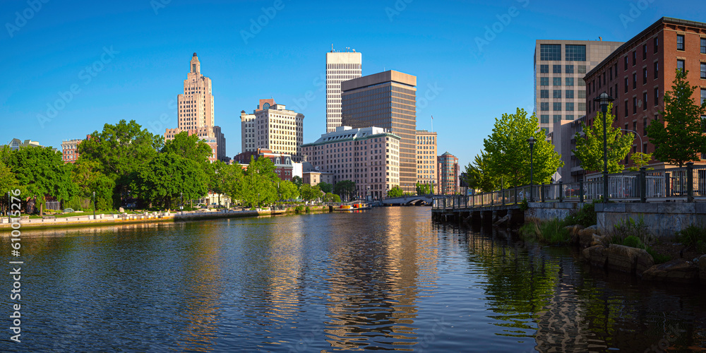 Downtown Providence skyline, city park, and building reflections at sunrise over the river in Rhode Island