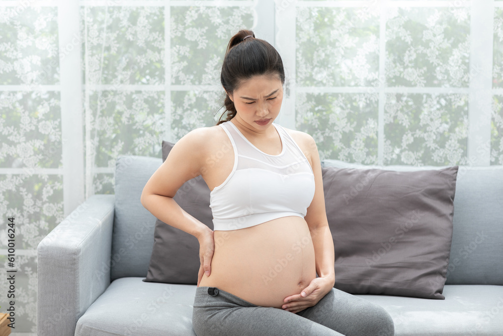 Pregnant woman touching on tummy and on her back so painful,Pregnancy of woman suffering from backache after wake up stress on her muscle,Health Care of Pregnancy concept Pregnant woman touching on tummy and on her back so painful,Pregnancy of woman suffering from backache after wake up stress on her muscle,Health Care of Pregnancy concept