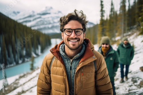 Portrait of a young man with friends on the background of mountains