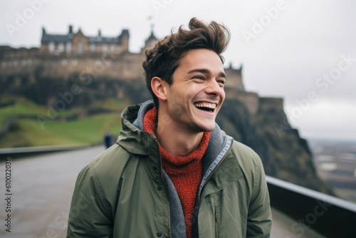 Lifestyle portrait photography of a grinning man in his 20s that is smiling with friends at the Edinburgh Castle in Edinburgh Scotland . Generative AI
