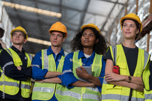 Group of warehouse workers standing with crossed arms in storage warehouse. Complete finish job. Successful of work concept