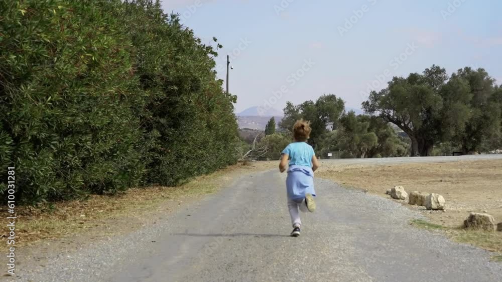 Child running rural country road in village, summer vacation, adventure, happy childhood. Active exploring lifestyle, travel with family children. Child running rural country road in village, summer vacation, adventure, happy childhood. Active exploring lifestyle, travel with family children.