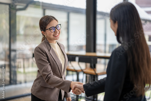 smiling business woman shake hands greeting getting acquainted in office, shake hands deal make agreement after successful negotiation