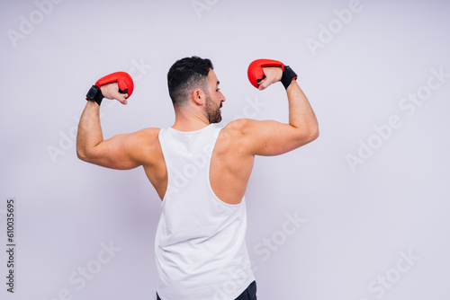 Man boxer in red sport boxing gloves at studio, copy space.