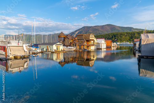 Fototapeta Naklejka Na Ścianę i Meble -  A row of different styles of boathouses and float homes at a marina on Lake Pend Oreille in the small town of Bayview, Idaho, near Coeur d'Alene in the Northern Idaho panhandle.