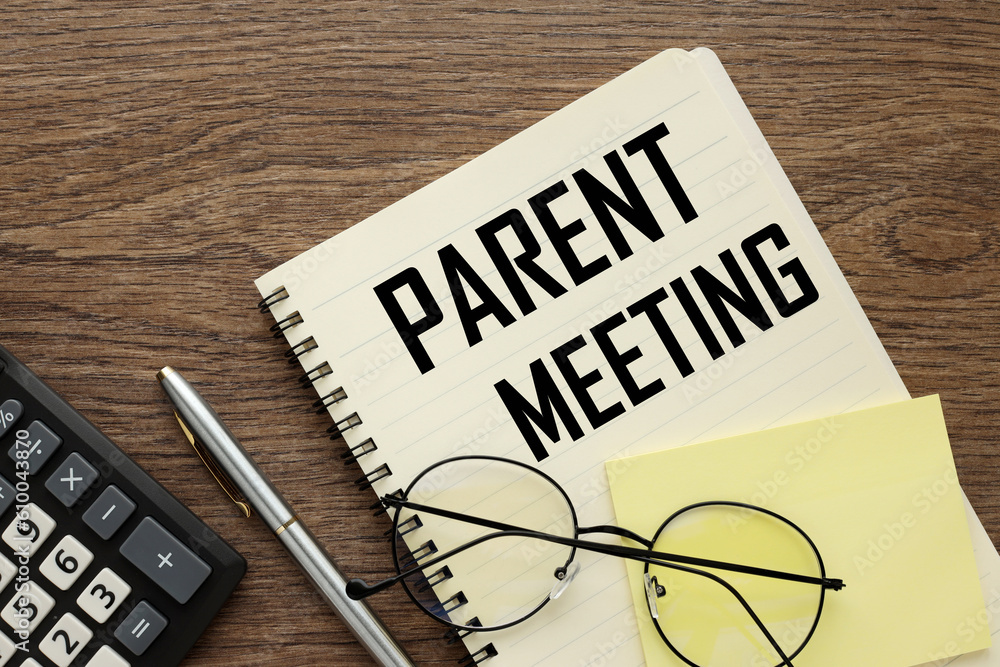 glasses on a notebook with the text Parent Meeting on the desktop glasses on a notebook with the text Parent Meeting on the desktop