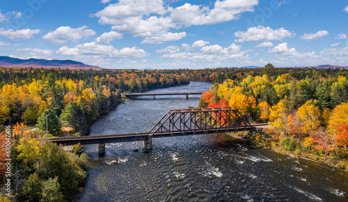 Autumn colors on the river at Moosehead Lake, Maine - train trestle photo