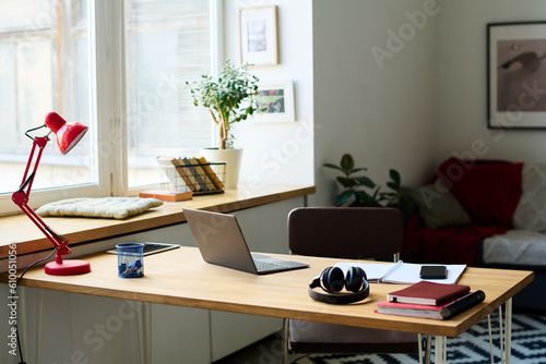 Modern workplace with laptop for online work in the room at home