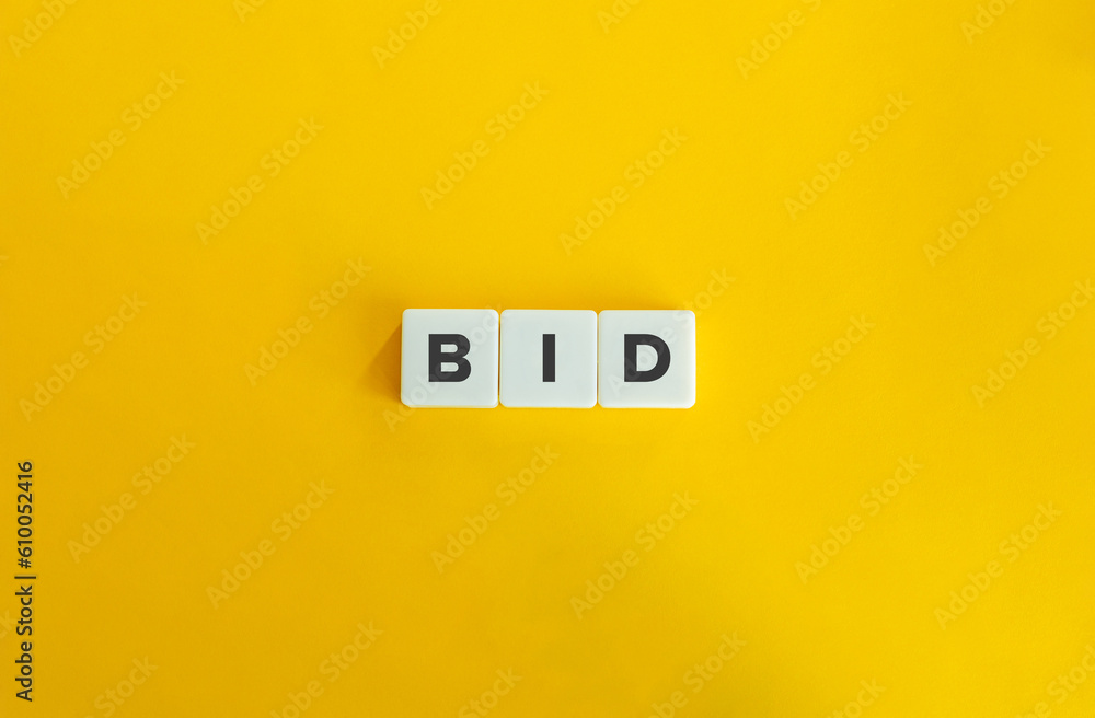 Bid Word on Block Letter Tiles on Yellow Background. Minimal Aesthetics. Bid Word on Block Letter Tiles on Yellow Background. Minimal Aesthetics.