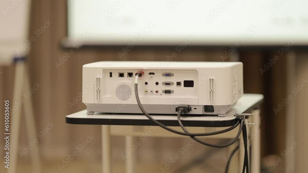 Screen projector. the projector is showing video. digital video projector on a stand, rear view. video projector at a business conference, seminar or lecture in the office, on a stand. Screen projector. the projector is showing video. digital video projector on a stand, rear view. video projector at a business conference, seminar or lecture in the office, on a stand.