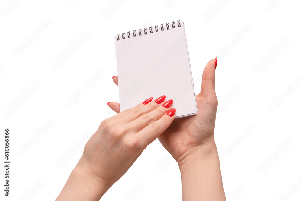 A notebook with empty white paper in woman hands with red nails. A notebook with empty white paper in woman hands with red nails.