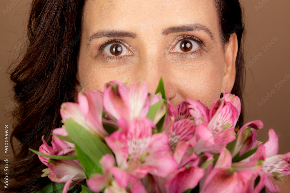 Close-up portrait of beautiful Caucasian woman holding bouquet of flowers close to her face. Passionate, happy person. Close-up portrait of beautiful Caucasian woman holding bouquet of flowers close to her face. Passionate, happy person.
