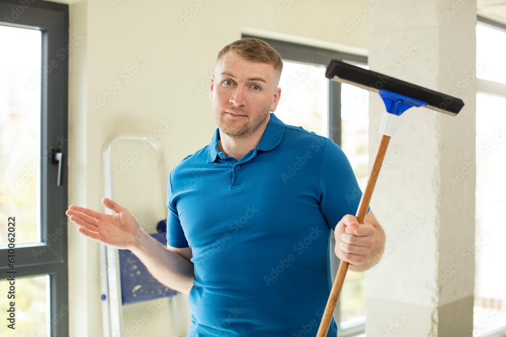shrugging, feeling confused and uncertain. windows washer shrugging, feeling confused and uncertain. windows washer