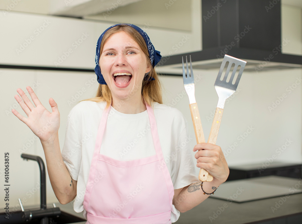 young pretty woman feeling happy and astonished at something unbelievable. home chef concept young pretty woman feeling happy and astonished at something unbelievable. home chef concept