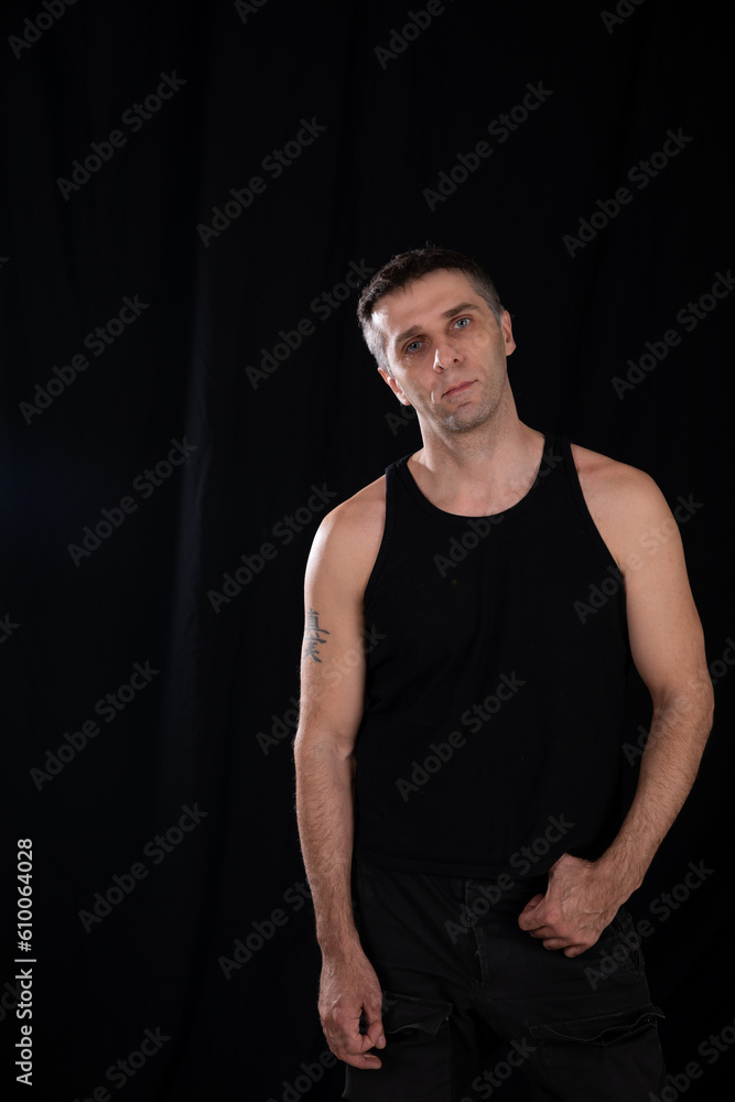 a man posing in a dark room on a black background a man posing in a dark room on a black background