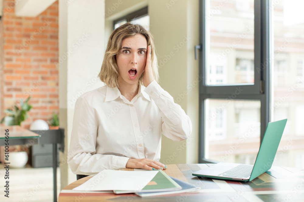 pretty woman feeling extremely shocked and surprised. home work telecommuting concept pretty woman feeling extremely shocked and surprised. home work telecommuting concept
