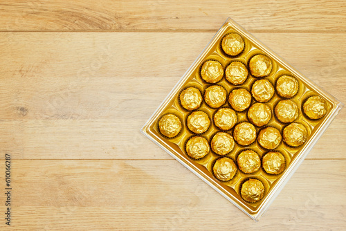 golden premium chocolate sweets box on wood table for holidays