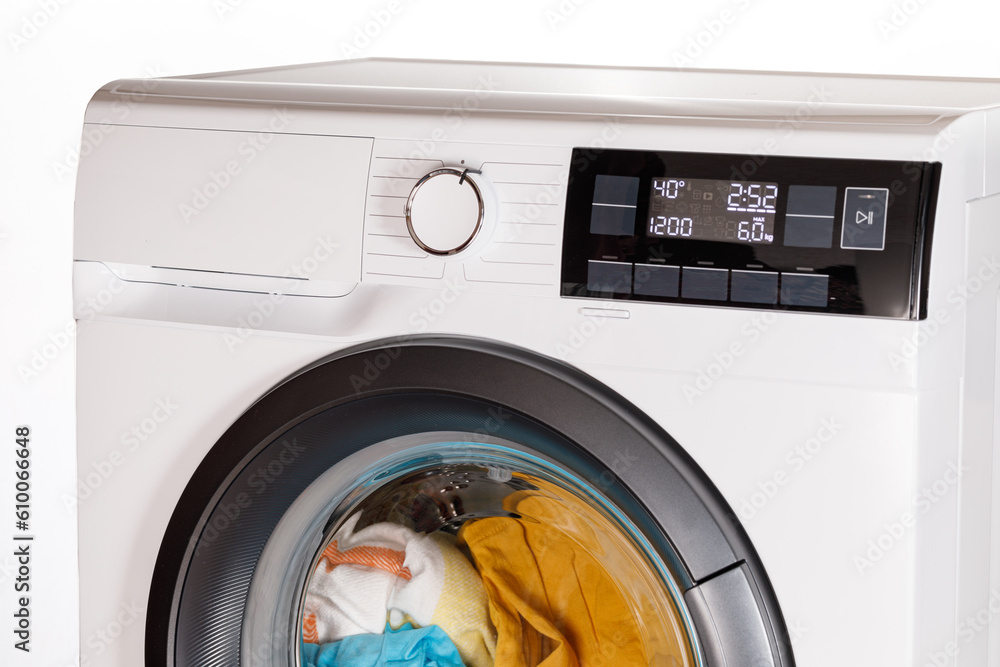 The hand select settings for laundry on modern digital display. Close-up view of automatic washing machine with touch screen on control panel. Press start or pause The hand select settings for laundry on modern digital display. Close-up view of automatic washing machine with touch screen on control panel. Press start or pause