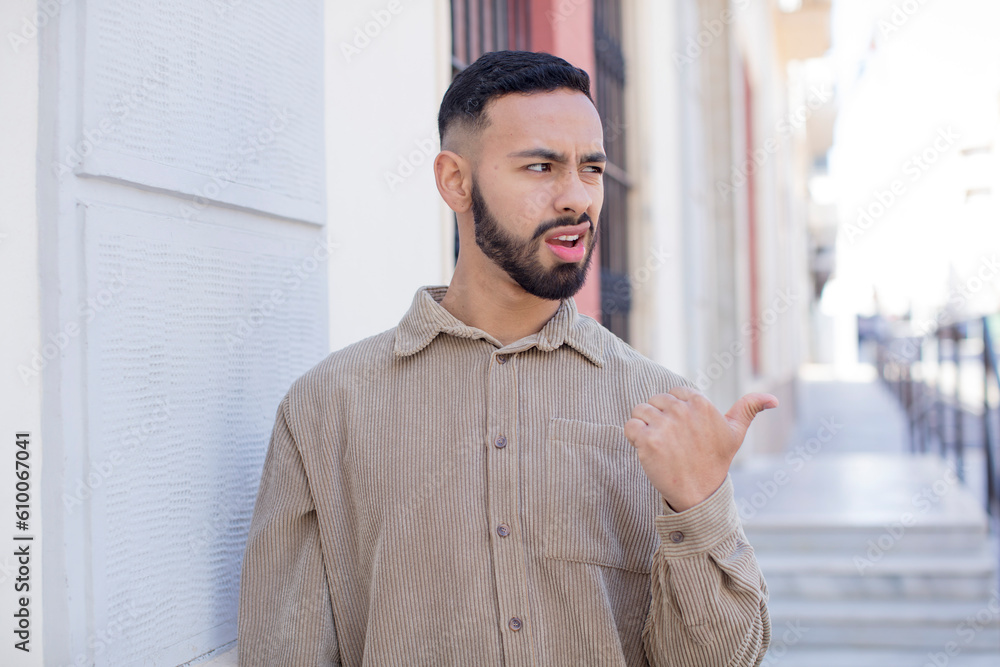 Obraz premium young handsome man worried, feeling scared, frustrated and stressed