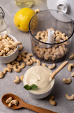 Cashew nut cream cheese in a white bowl and cooking ingredients
