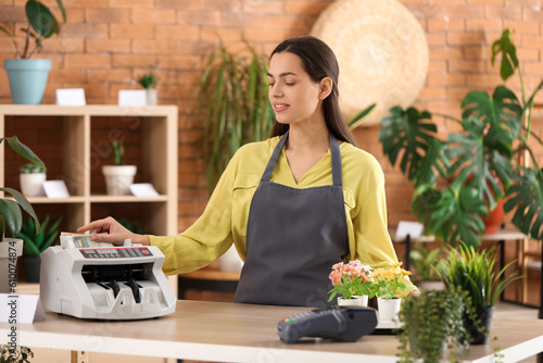 Female cashier using cash c...