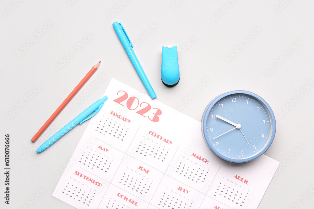 Calendar, pencils and clock on grey background Calendar, pencils and clock on grey background