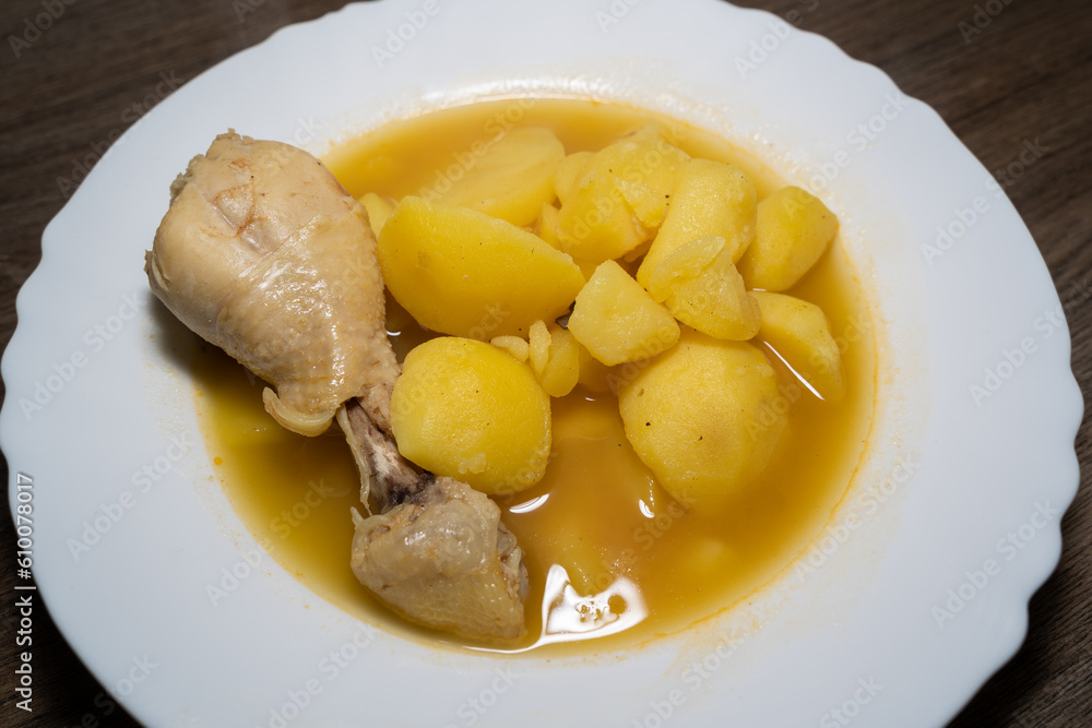 Homemade potato soup with chicken drumsticks in a white plate Homemade potato soup with chicken drumsticks in a white plate