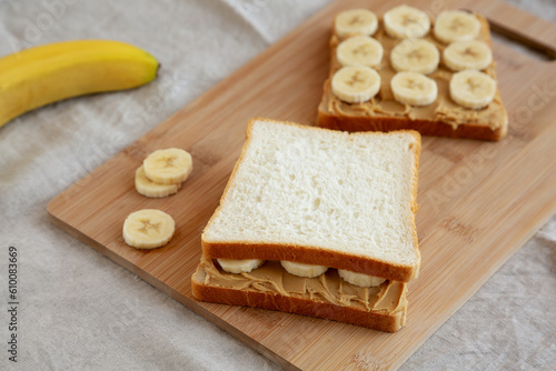 Homemade Peanut Butter Banana Sandwich on a Bamboo Board, side view.