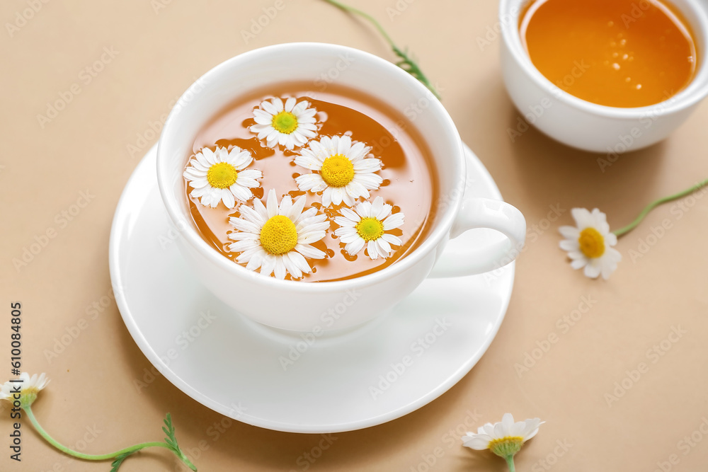 Cup of hot chamomile tea with honey on beige background Cup of hot chamomile tea with honey on beige background