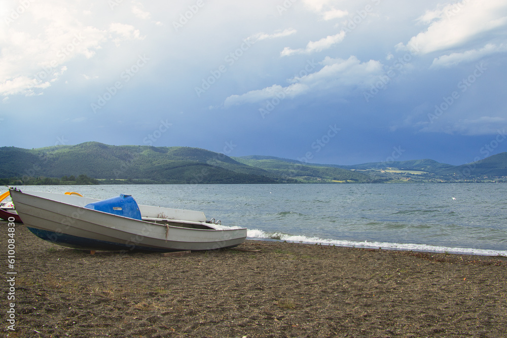 boats on the beach with mountains in background in Italy