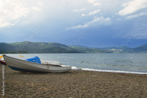boats on the beach with mountains in background in Italy