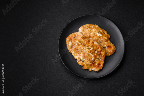 Delicious fried chicken breast in batter with mustard, salt, spices and cheese