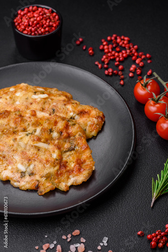 Delicious fried chicken breast in batter with mustard, salt, spices and cheese