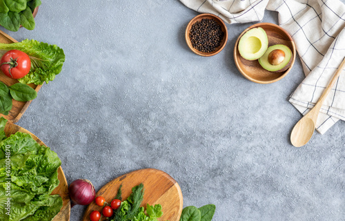 Lettuce, tomato, parsley, avocado and onion on a gray background. The concept of vegetarian food, healthy lifestyle and nutrition