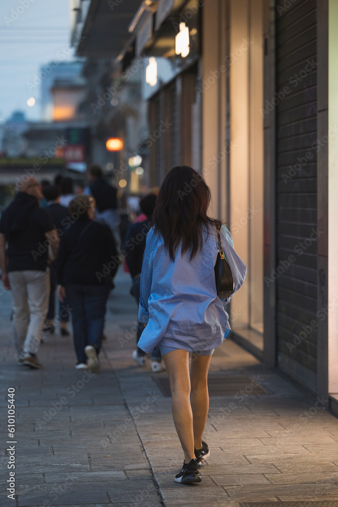 A girl walking around the city of Milan