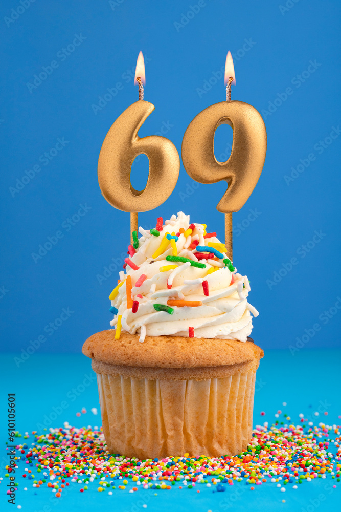 Birthday cake with candle number 69 - Blue background