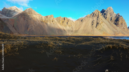 Stokksnes beach with rocky mountains, majestic vestrahorn mountains next to natural black sand beach in iceland. Panoramic view of icelandic landscape and landmarks, scenic route. © DC Studio