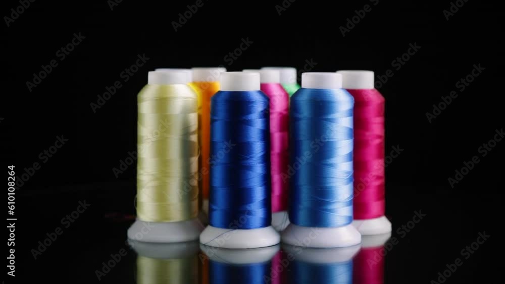 set of different color sewing threads,on black background. set of different color sewing threads,on black background.