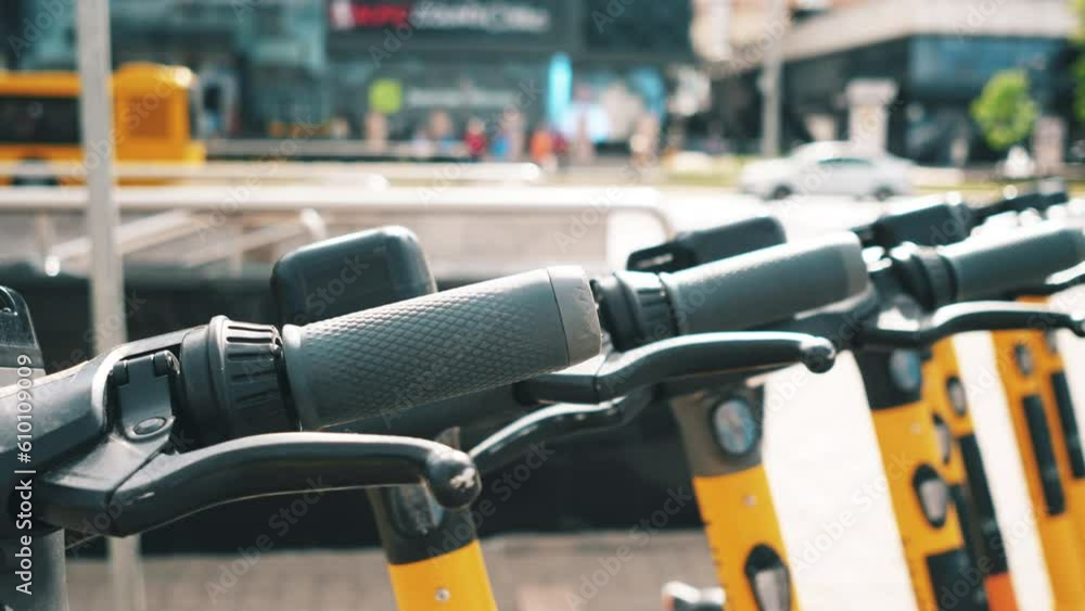 Electric scooters for rent parked in a row in the city 4k Electric scooters for rent parked in a row in the city 4k