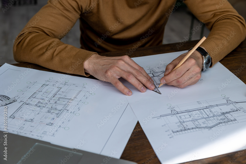 Architect drawing blueprint sketching design of house, making architectural construction building. Architect drawing blueprint sketching design of house, making architectural construction building.