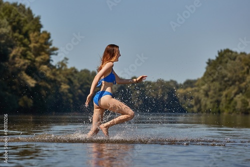 Girl at the beach running into the water