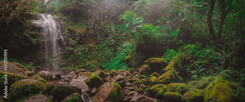 Beautiful waterfall in Boquete part of Panama called the hidden waterfalls. Beautiful jungle setting with lush greens and big moss covered rocks and enchanting waterfall.